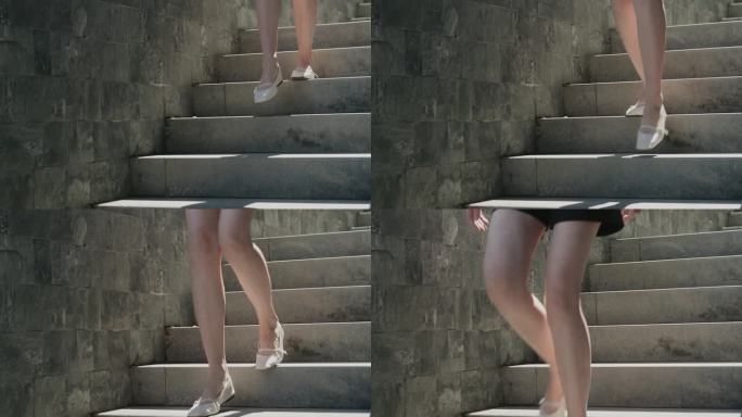 穿短裤的女孩正在下楼。街上的楼梯。