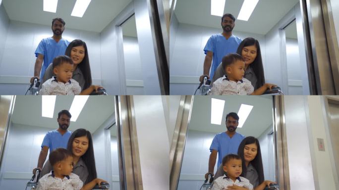 医务人员或医生用轮椅将母子从医院走廊的电梯里抬出来。