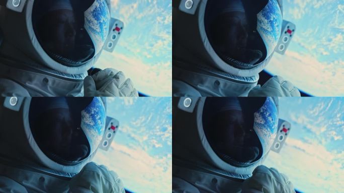 亚洲华裔中年女航天员在太空飞船上透过窗户看地球