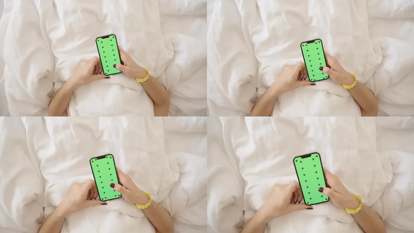 在酒店点餐或打扫房间的概念。躺在床上时，女性的手可以滚动带有绿屏模型和跟踪标记的智能手机。前视图。