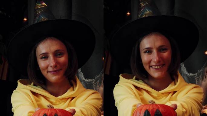 戴着女巫帽的女孩手里拿着南瓜，脸上画着诡异的表情。垂直视频