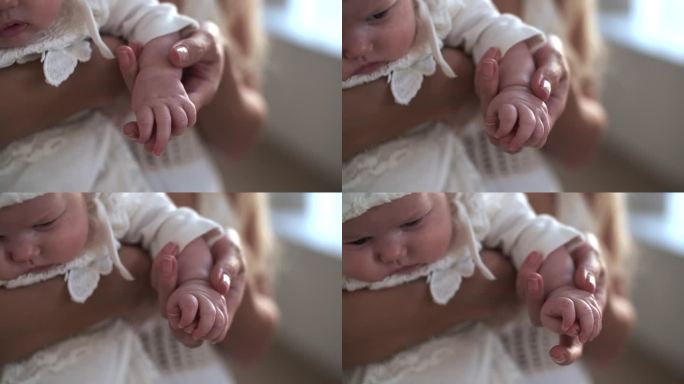 母亲的手握着婴儿的手掌。特写镜头。