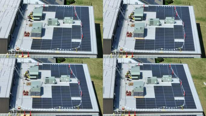 美国工业厂房上的大型太阳能电池板阵列。美国屋顶绿色能源主题。可再生电力，清洁能源，低碳足迹。