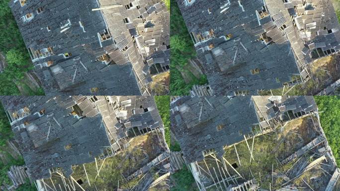 空中拍摄的苏联牛棚屋顶的废墟。镜头向后移动