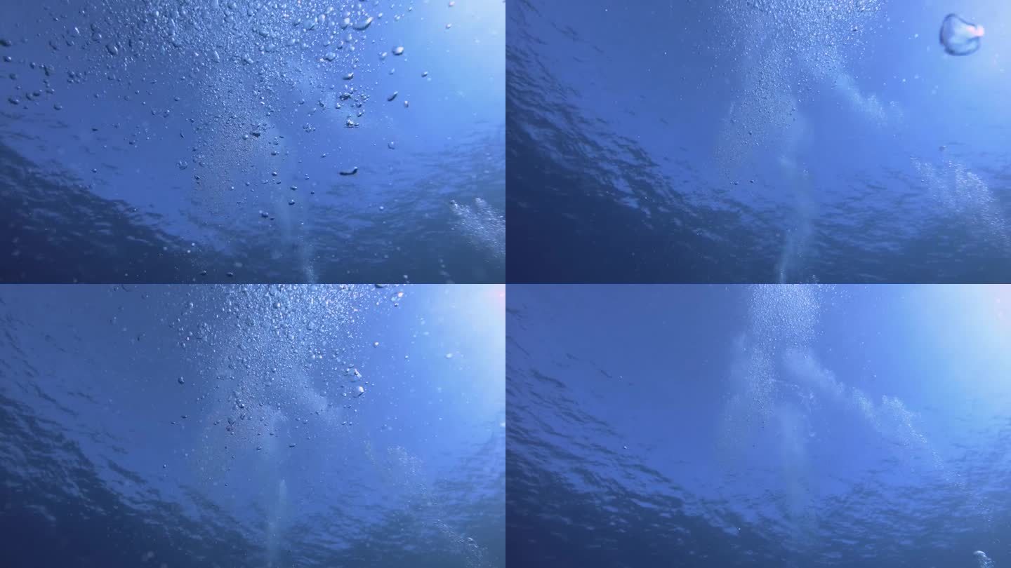 从下往上看，海面上的气泡飞溅运动上升到水下和阳光光束