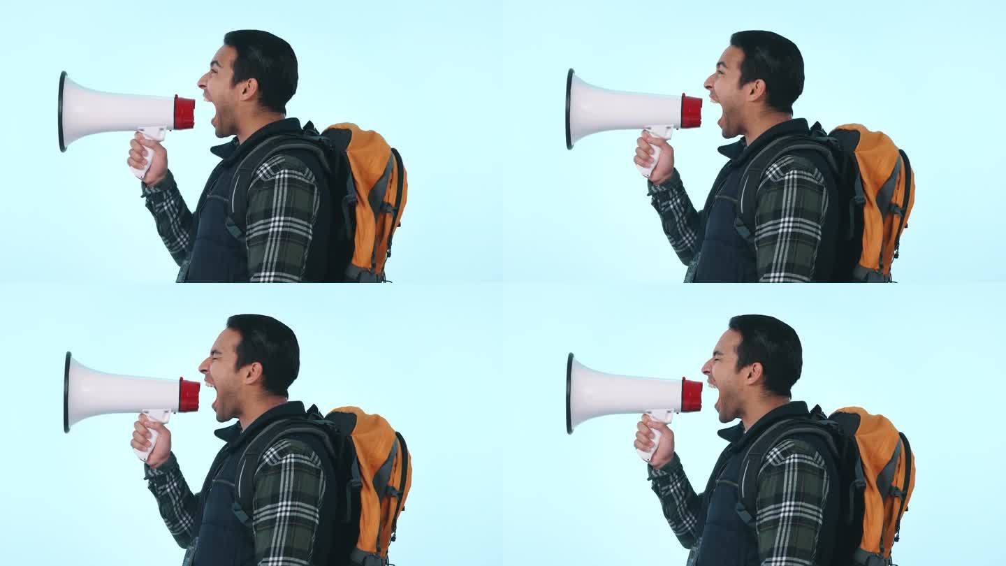一名男子拿着扩音器，背着背包大声抗议，在演播室的背景下发出声音或公告。男性人士或激进分子的侧面特写，