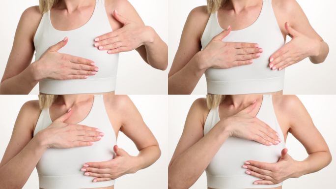 穿白色上衣的女人触摸乳房来检测痛点