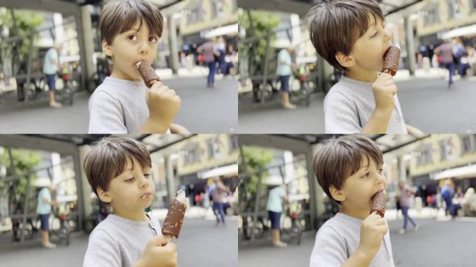 一个小男孩在城市里散步时喜欢吃他的巧克力甜筒冰淇淋