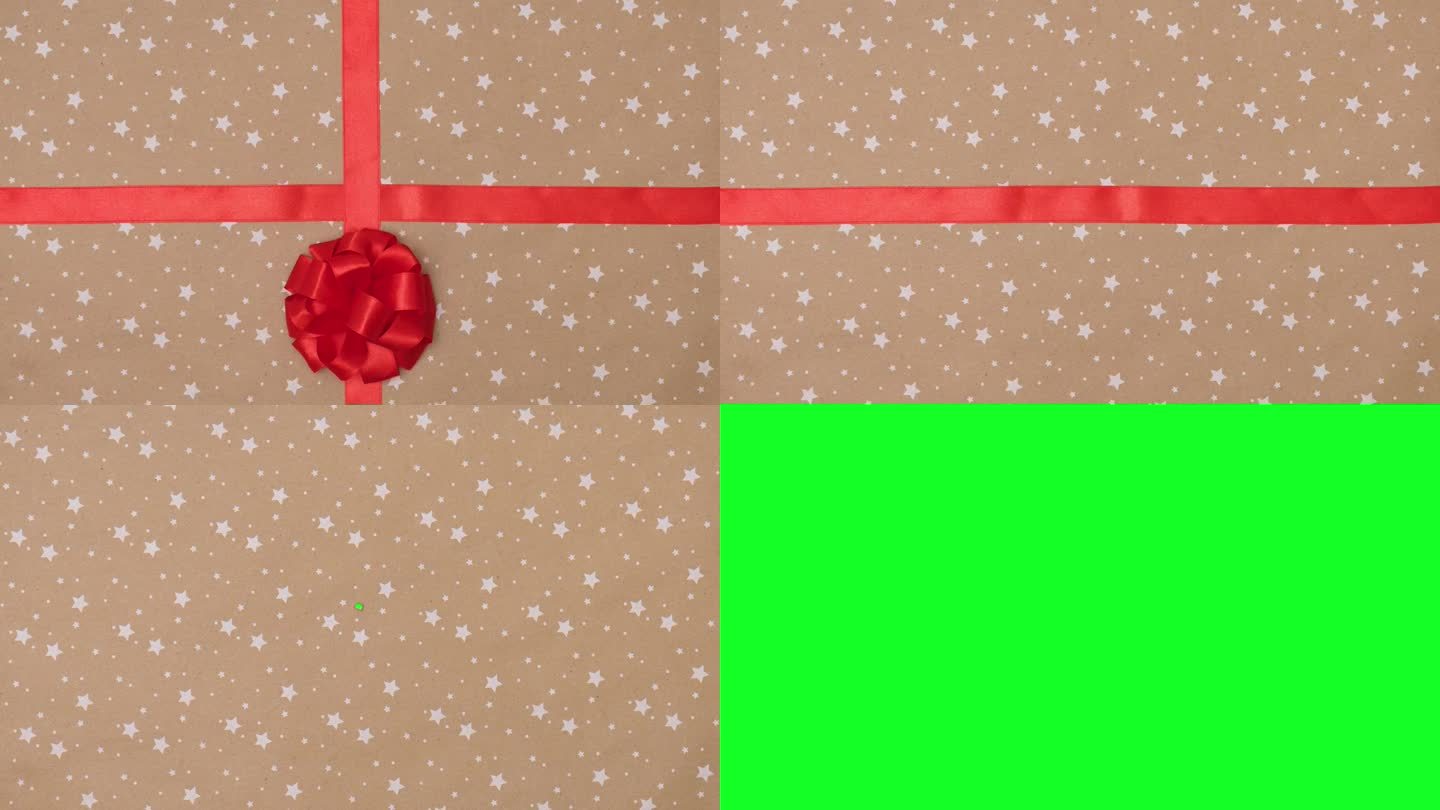 拆开礼物，用红色缎带和手工蝴蝶结系在星星背景的工艺纸上。揭示绿屏定格动画。