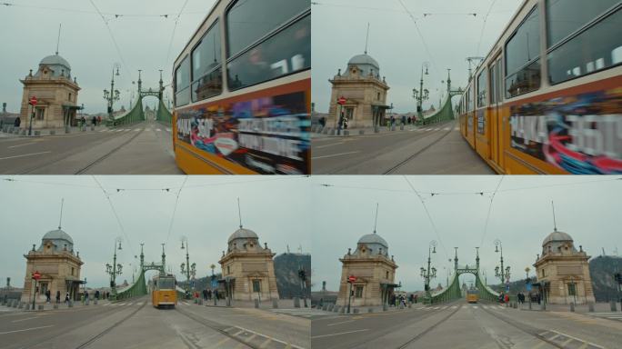 手持拍摄的有轨电车移动在自由桥对天空在布达佩斯，匈牙利