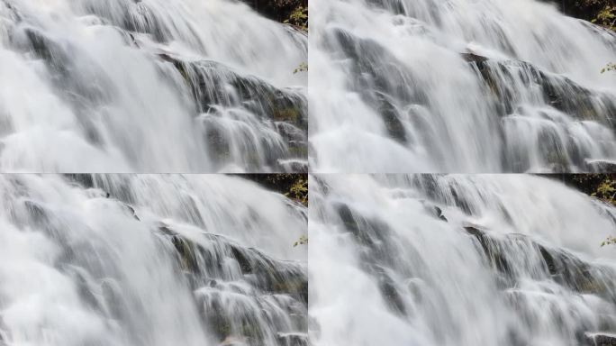 瀑布特写长曝光山崖悬崖高山流水缓缓流淌