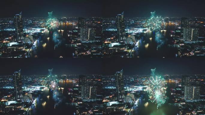 多色烟花表演在城市景观和摩天大楼庆祝夜晚的灯光，河流和曼谷大桥