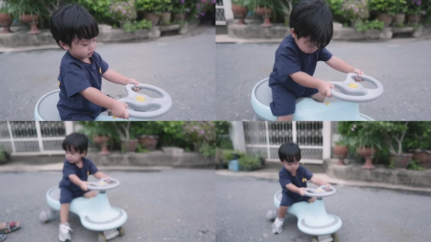 一个亚洲男孩在玩玩具车。有趣的骑。
