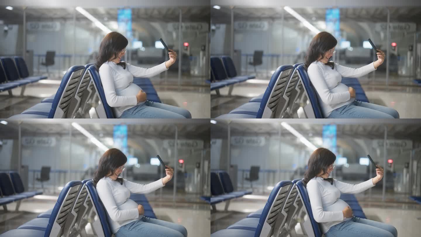 一位快乐的孕妇坐在机场用手机进行视频通话