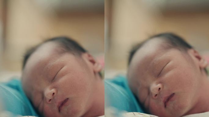 亚洲母亲和刚出生的男婴在医院病房拥抱爱——发自内心的母性和育儿时刻。