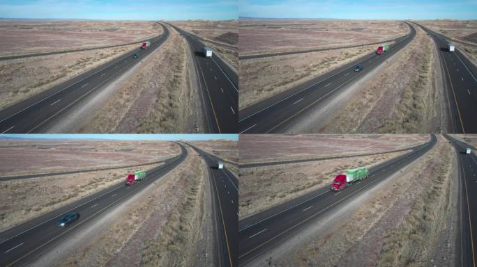 无人机拍摄的半卡车与平板拖车装载物资在一个阳光明媚的冬日双车道州际公路