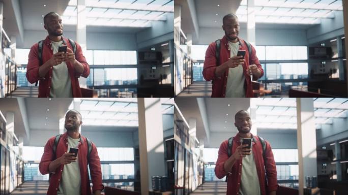 一个大学生的肖像，一边看手机，一边微笑着走向教室。年轻的黑人男子穿过大楼的大厅。低角度