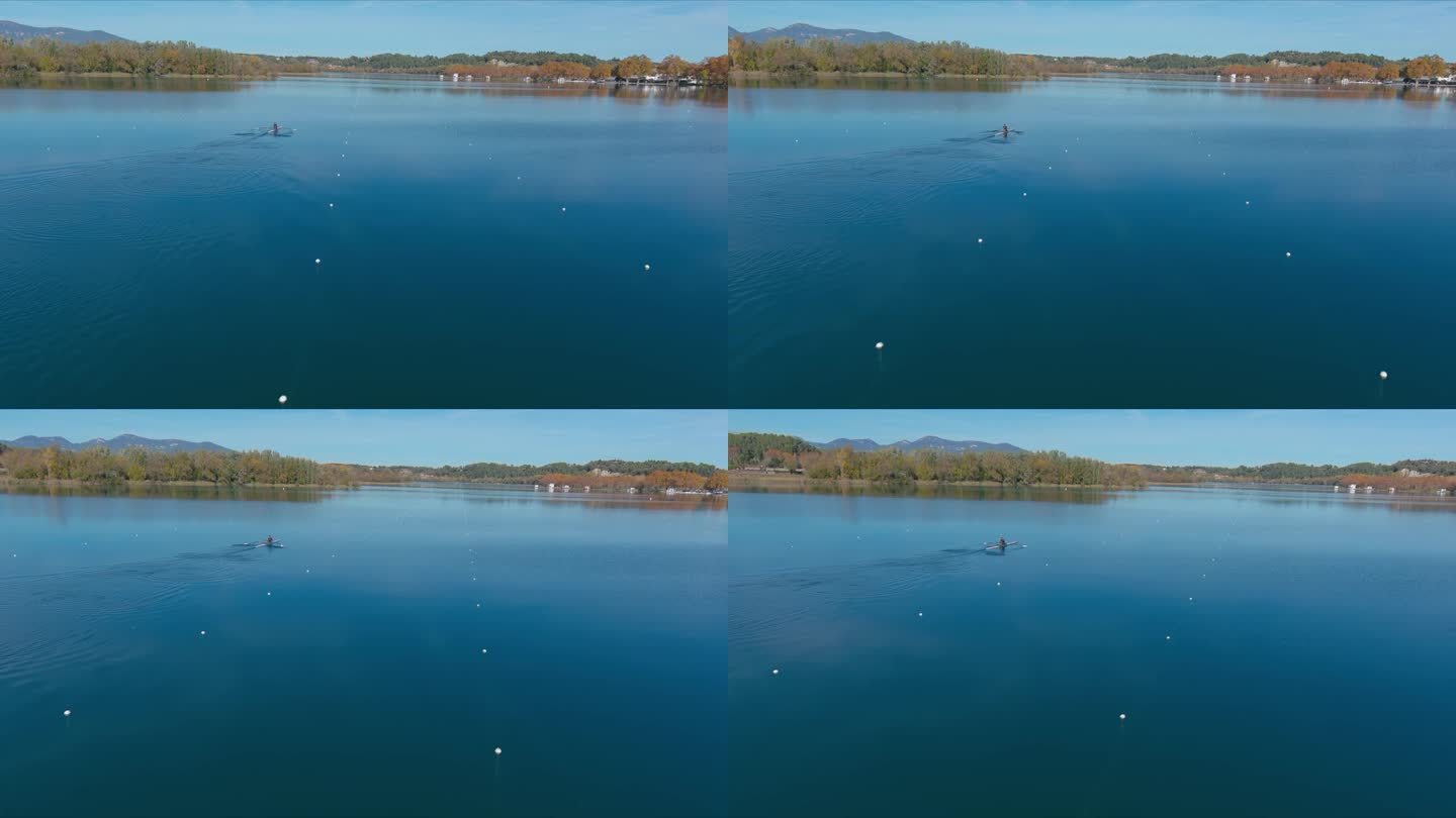 在赫罗纳的秋天，一个人划着两只桨横渡班约莱斯湖
