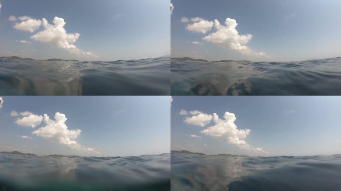 夏季室外游泳池的水波面，天空中有云的运动场景