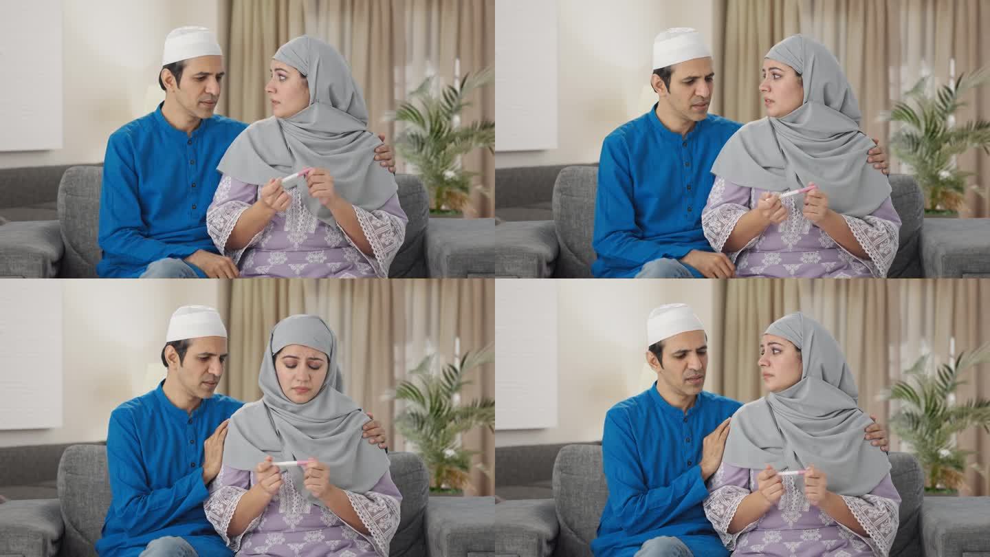 紧张的穆斯林夫妇检查怀孕测试