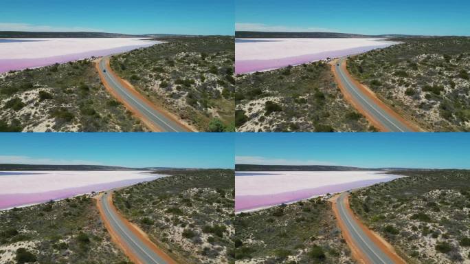 汽车在西澳大利亚粉色赫特泻湖旁行驶的航拍照片。