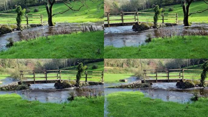 漫溢的河水冲垮了河岸，阳光浸透了北威尔士木桥下的草地