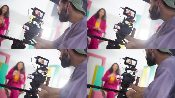 近距离拍摄一位穿着彩色衣服的女电视主持人:慢动作捕捉热情的内容创作者为她的在线频道制作视频的幕后镜头