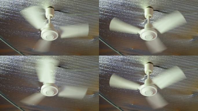 安装好的吊扇在炎热的夏天旋转。天花板上的热反射膜