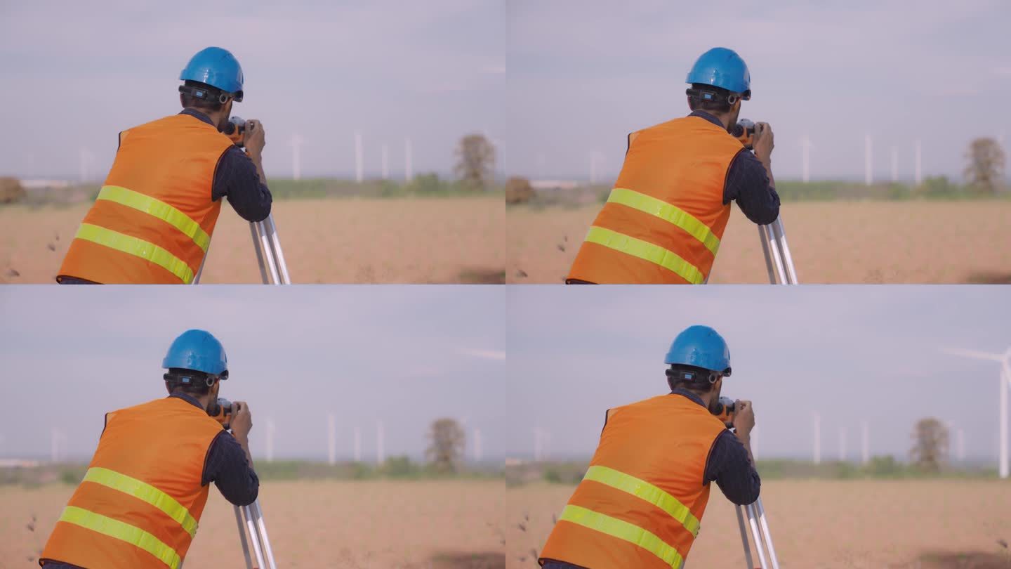 土地测量员在风力涡轮机农场施工现场。