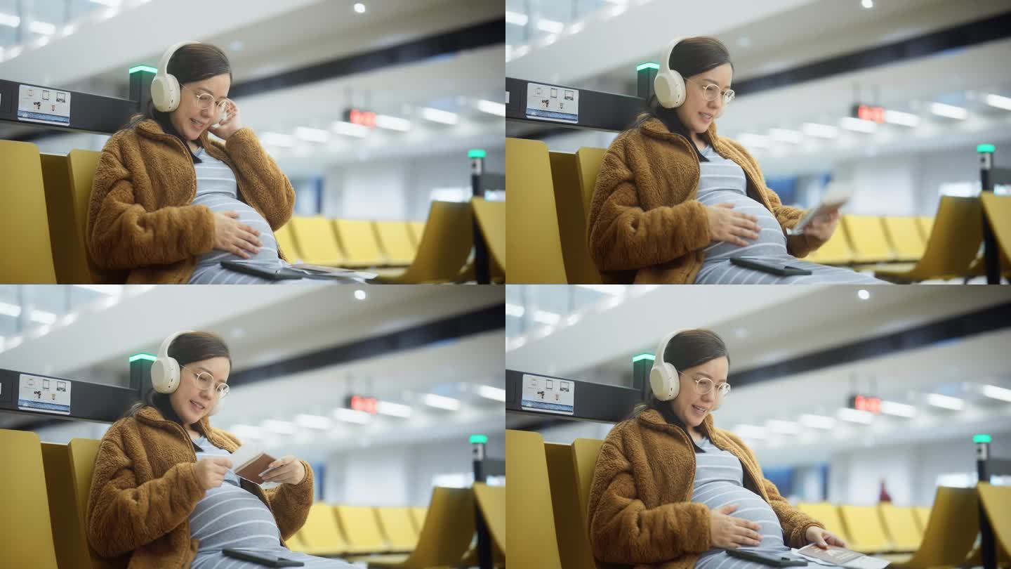 孕妇在机场候机时揉着肚子听着音乐