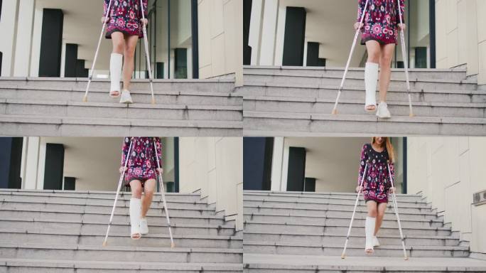 一条腿打了石膏拄着拐杖走下楼梯的女人