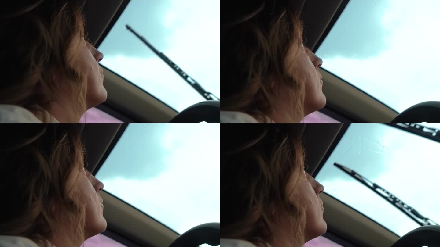 忧伤忧郁忧郁的女子在阴雨蒙蒙的天空中近距离看向车窗外