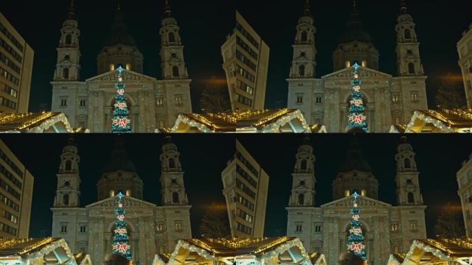 低角度手持拍摄的装饰圣诞节外圣斯蒂芬大教堂在晚上在布达佩斯，匈牙利