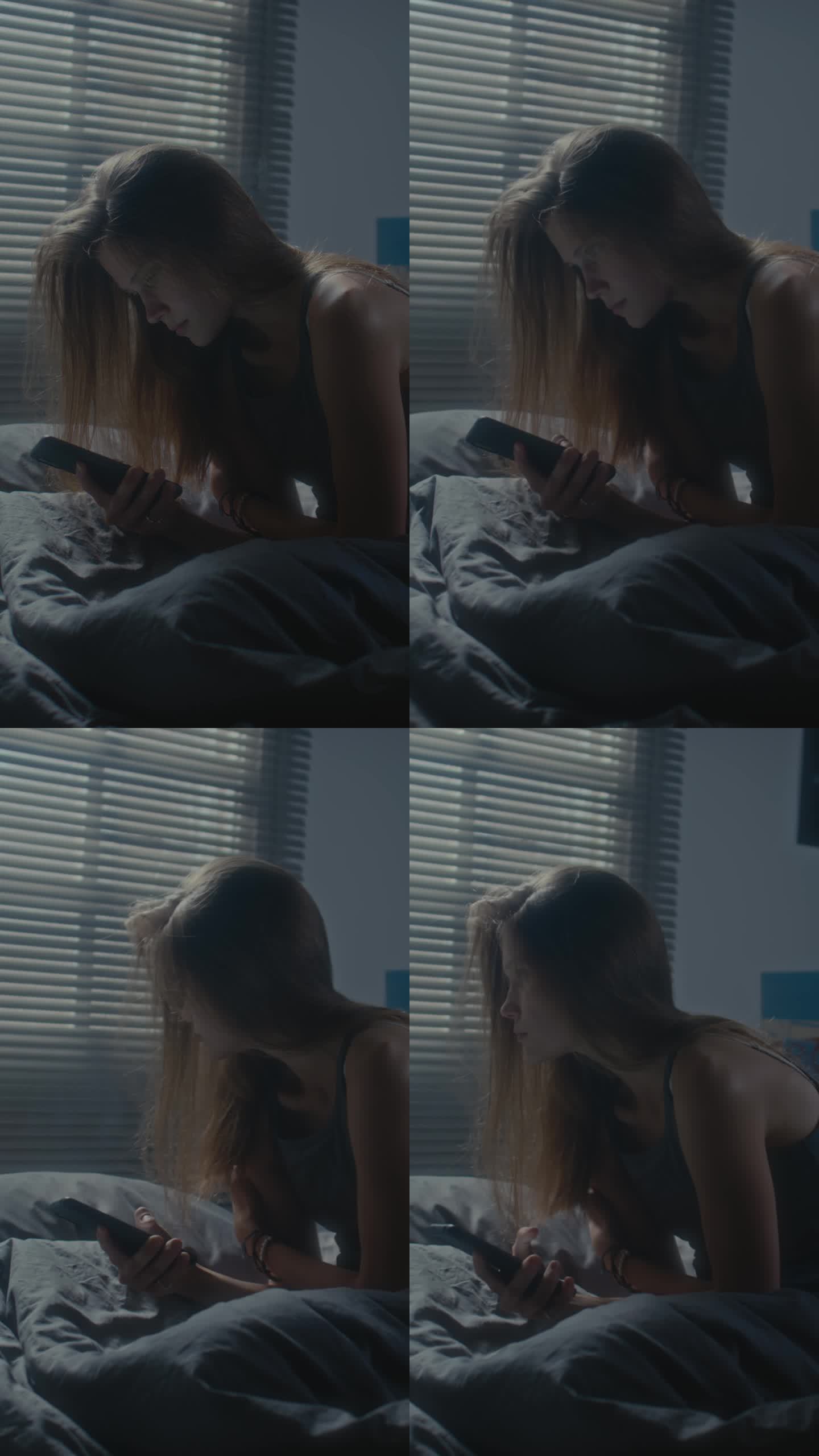 女孩坐在床上紧张地看手机