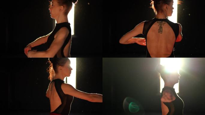 透过窗户照进来的阳光下，芭蕾舞女演员在黑暗的舞蹈大厅里表演了一段短腿舞。