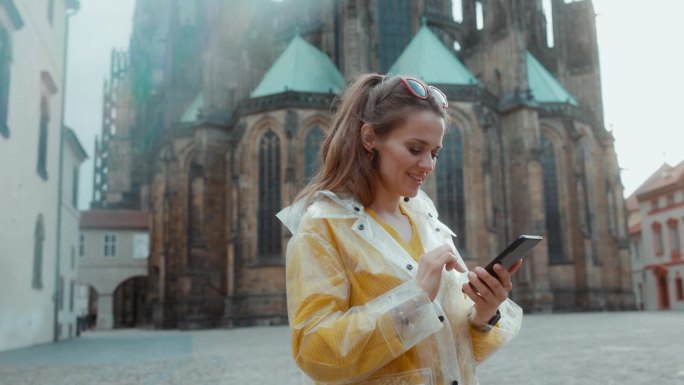 布拉格的一名女子一边散步一边使用智能手机