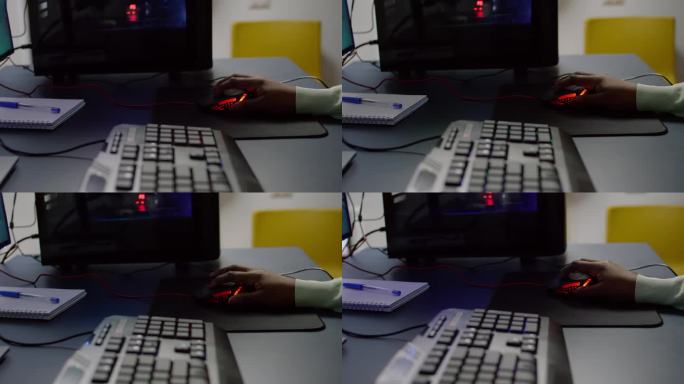 手持RGB鼠标玩太空射击游戏的streamer特写。