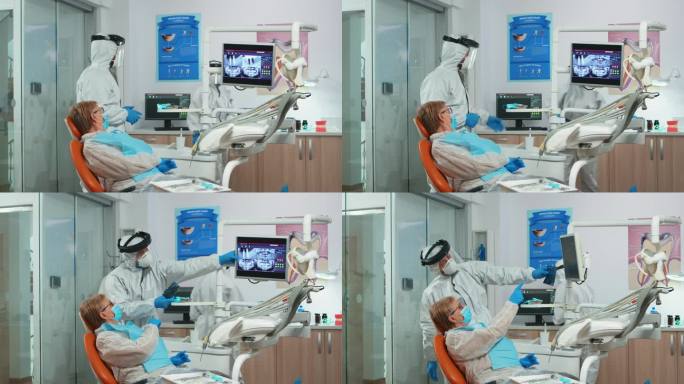 牙医全身穿著，显示病人的牙齿x光情况