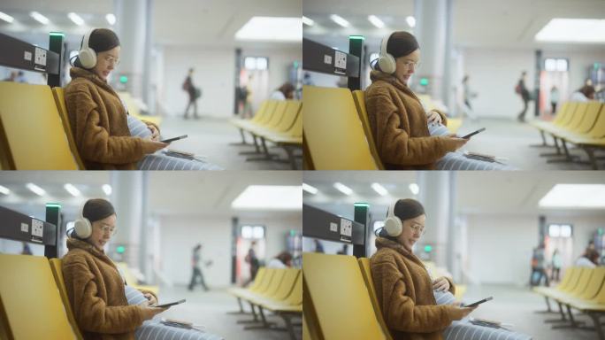 一名孕妇在机场候机时边听音乐边发短信
