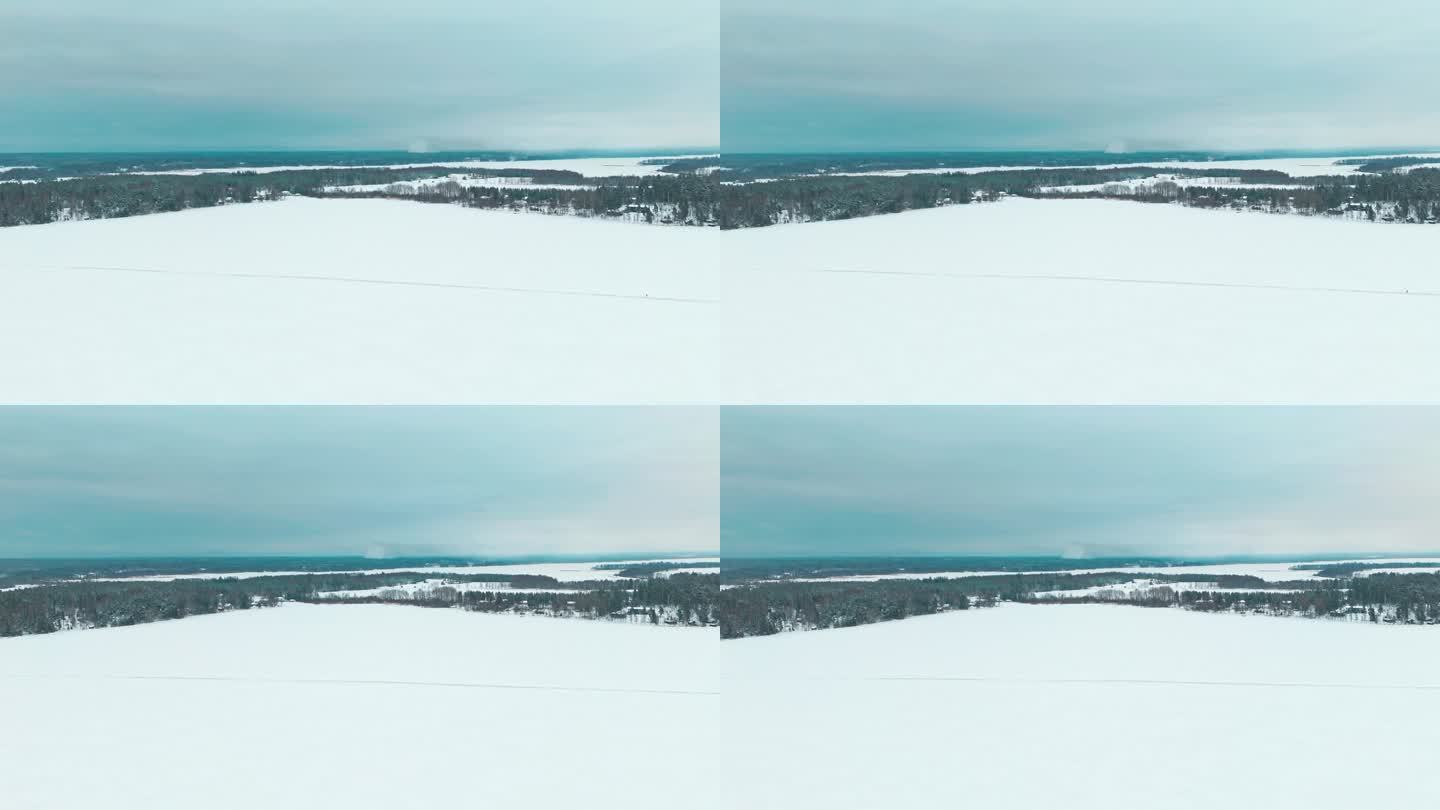 宽景拍摄的冰路，在冰冻的湖或海冰上的道路，用于快速旅行通过汽车或步行在冰冻的水。雪覆盖着冰和周围的森
