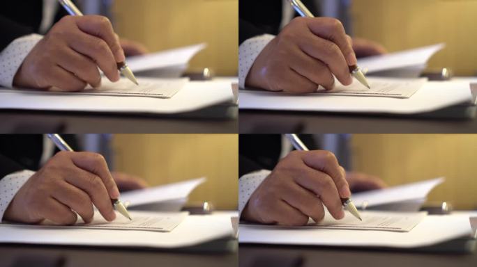 签署合同保险文件报告业务概念，商务经理手持笔阅读文件或文件文件的签名
