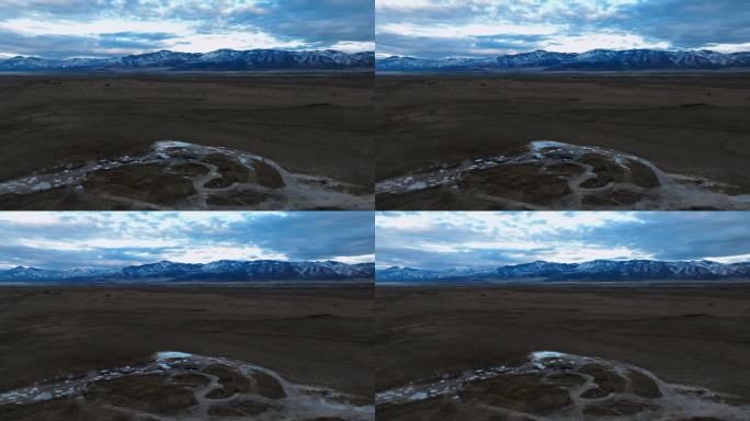 从日落时的草地温泉看雪山，犹他州米勒德县菲尔莫尔。空中静态拍摄，延时拍摄