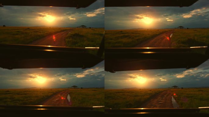 塞伦盖蒂的土路和明亮的夕阳，从游猎车上看