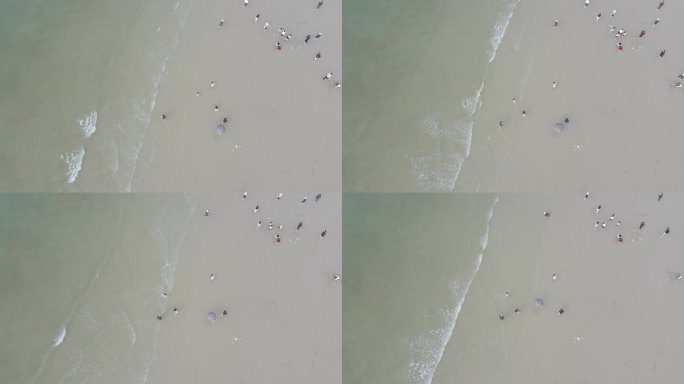 小孩沙滩玩耍海浪拍打沙滩浪花海岸线旅游