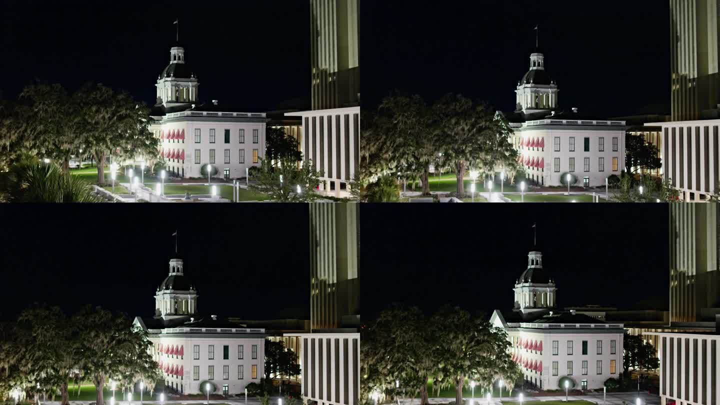佛罗里达州塔拉哈西的夜景:灯火通明的州议会大厦耸立在佛罗里达州塔拉哈西市中心的建筑物之上。航拍镜头与