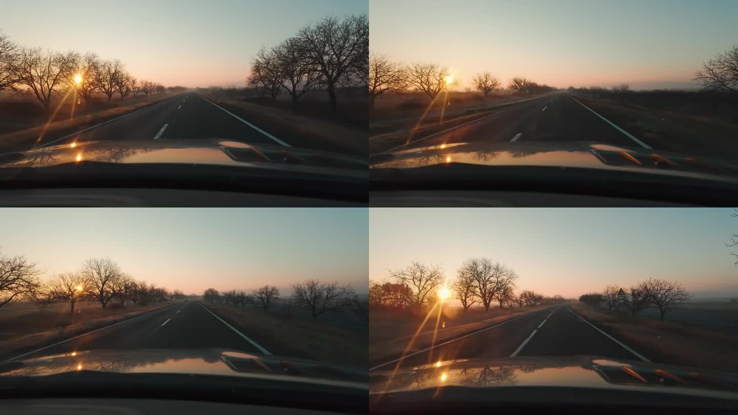 在日出的早晨，看到车窗和前方的道路，阳光灿烂