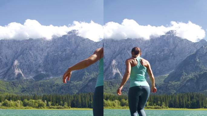 女性徒步旅行者的后视图与手臂伸展在岩石湖落基山脉