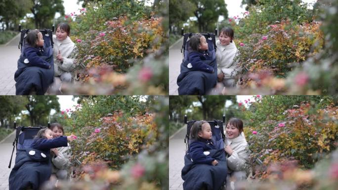 母亲和她的小女儿在玫瑰园看花