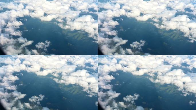 从飞机上鸟瞰日本上空的自然日出天空、绿色景观山和白云