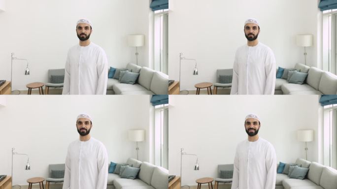 身穿传统白色坎杜拉服装的穆斯林男子在室内摆姿势
